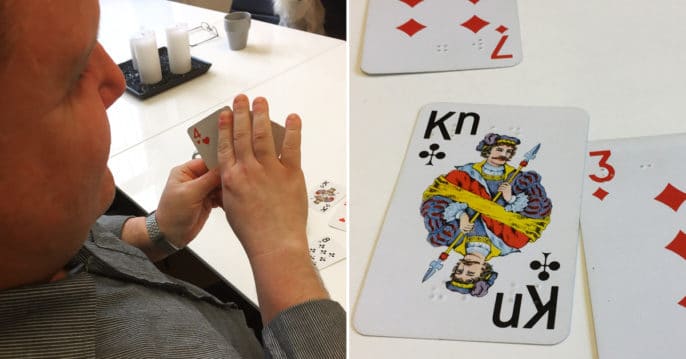 Till vänster, Fredrik med sin giv, läser av korten med höger hand. Till höger, närbild av spelkorten där man ser punktskriften.